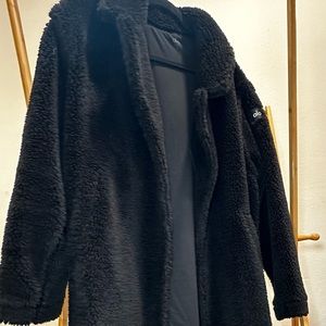 Designed for a long, oversized look—size down once if you prefer a closer fit.